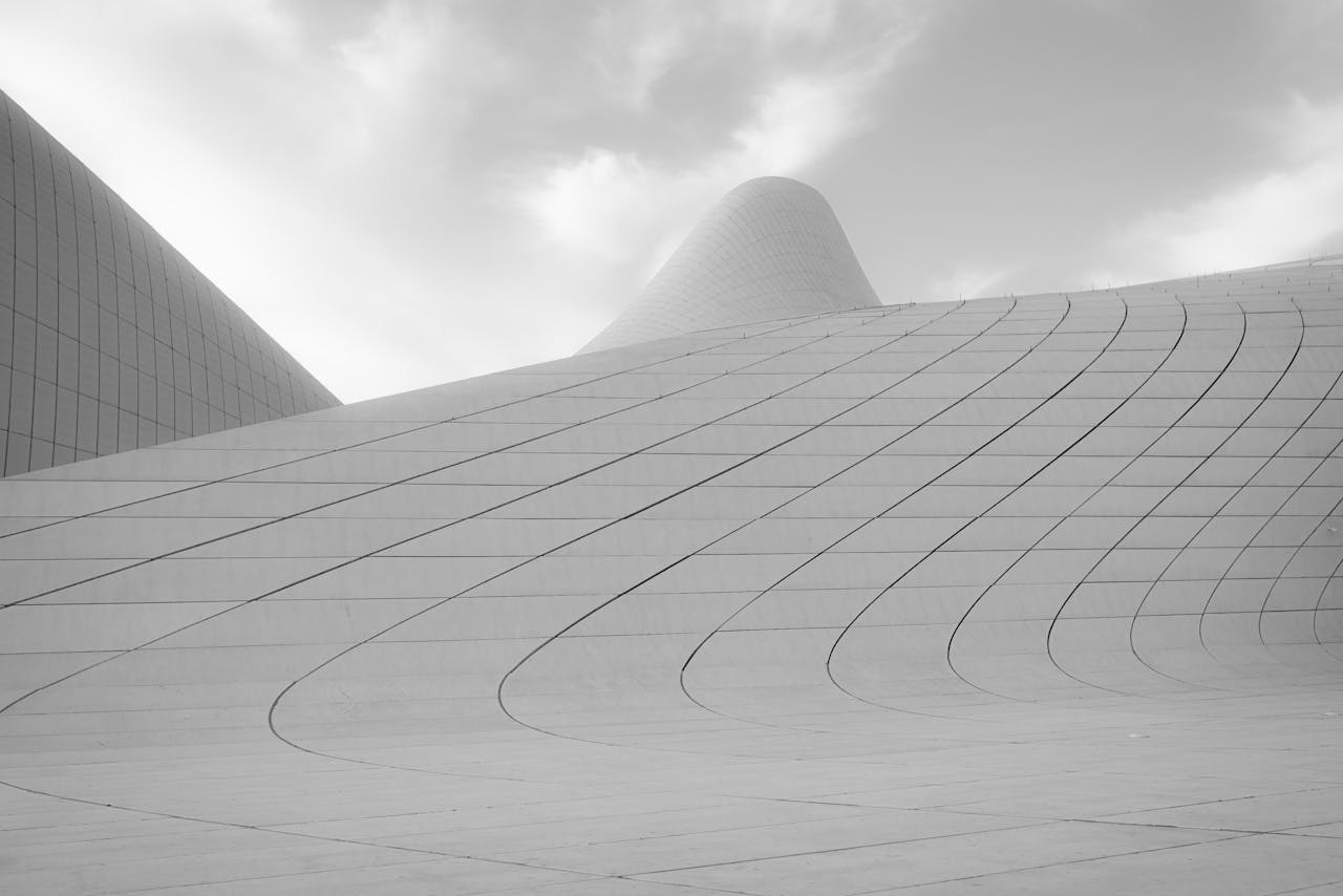 Sleek curves of Heydar Aliyev Center's exterior showcasing modern architectural design in black and white.